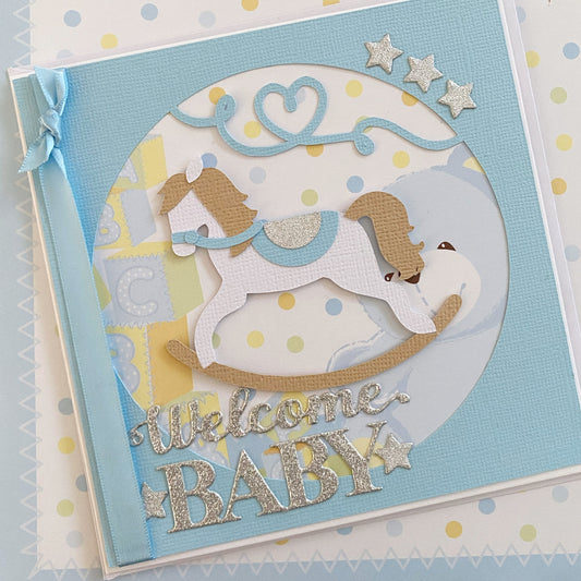 Rocking horse, new baby boy card. Welcome baby.